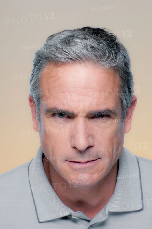 Studio Portrait of mature man staring at camera. Photo : Rob Lewine