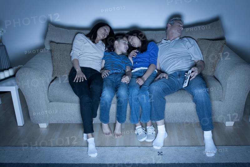 Family sitting on sofa sleeping. Photo : Rob Lewine