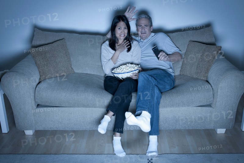 Couple watching television. Photo : Rob Lewine