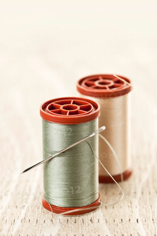 Spool of thread and needle. Photo : Elena Elisseeva