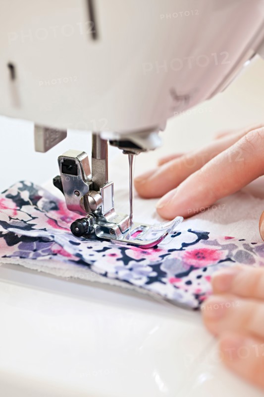 Close-up view of female hands operating machine . Photo : Elena Elisseeva