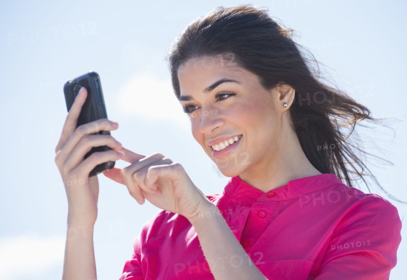 Young woman using PDA.