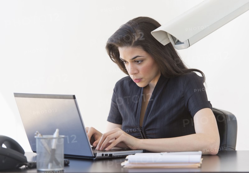 Businesswoman spied on by cctv camera.