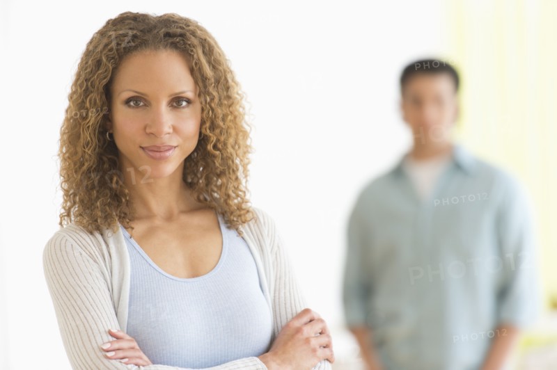 Portrait of couple with focus on woman in foreground.