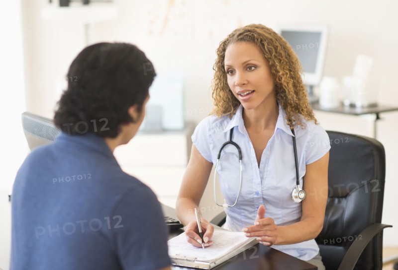 Doctor and patient talking in clinic.