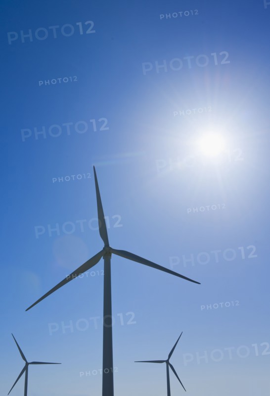 Wind turbine against blue sky.