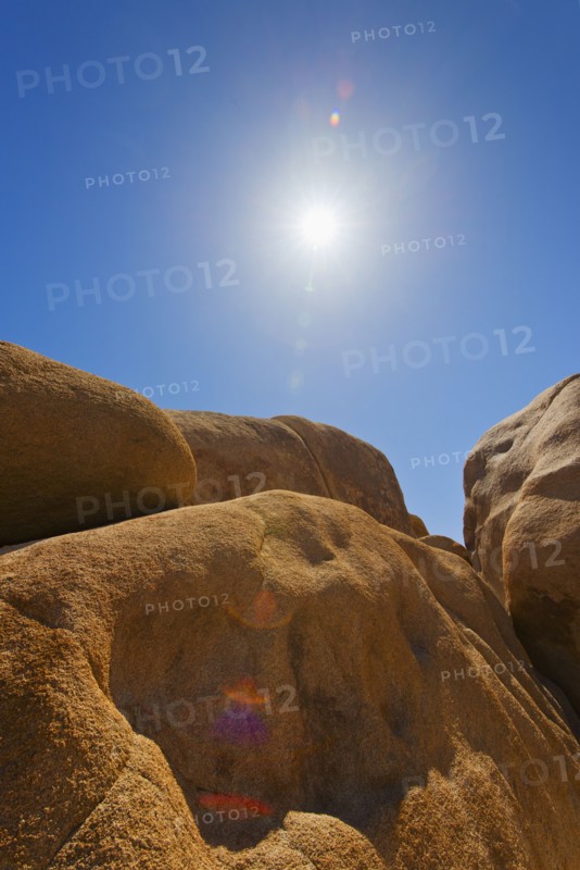 USA, California, Joshua Tree National Park, Desert rocks with solar flare.