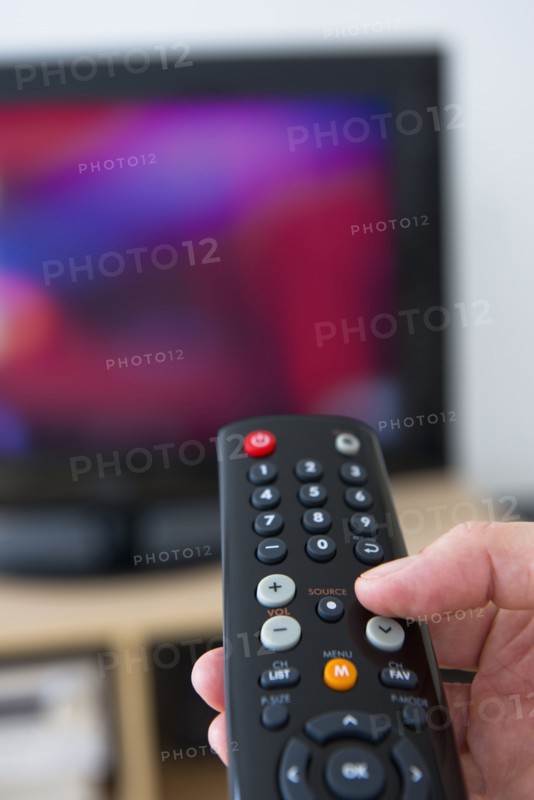 Hand using remote control.