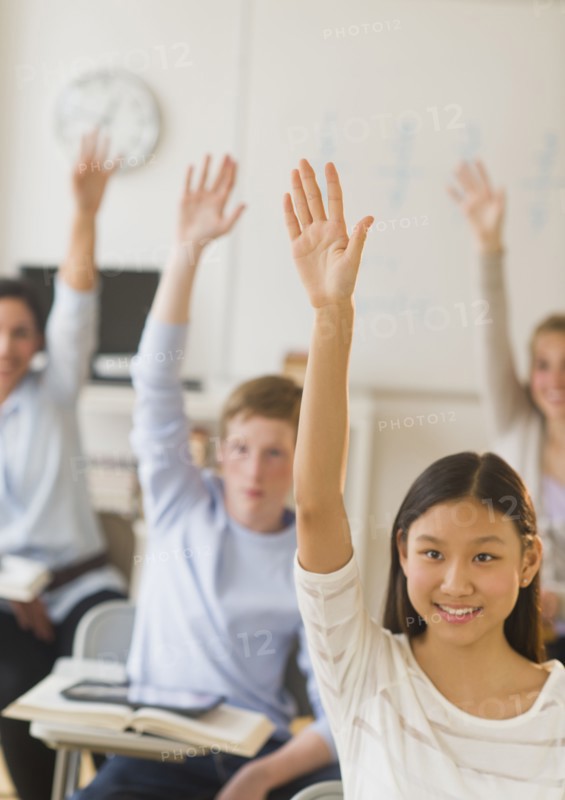 Students (14-19) raising hands.