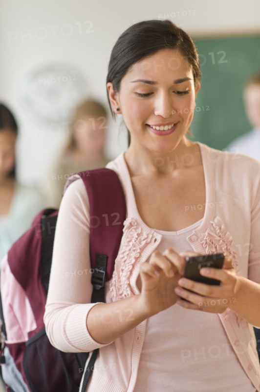 Female student texting on phone.