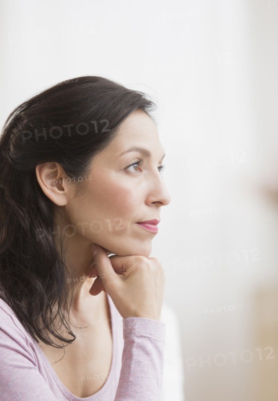 Woman with hand on chin.