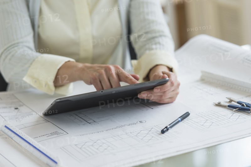 Architect working on digital tablet.