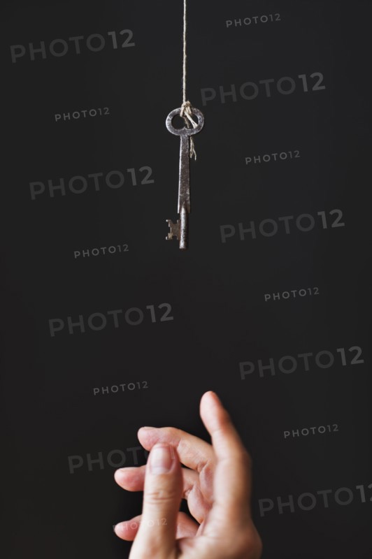 Hand reaching for key.