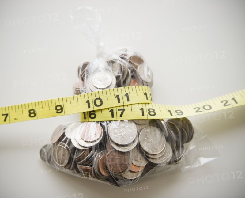 Savings in plastic bag tied up with tape measure. 
Photo : Jamie Grill