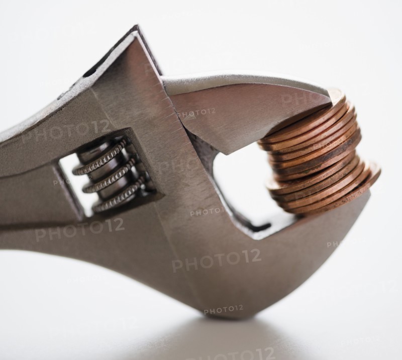 Wrench squeezing coins. 
Photo: Jamie Grill