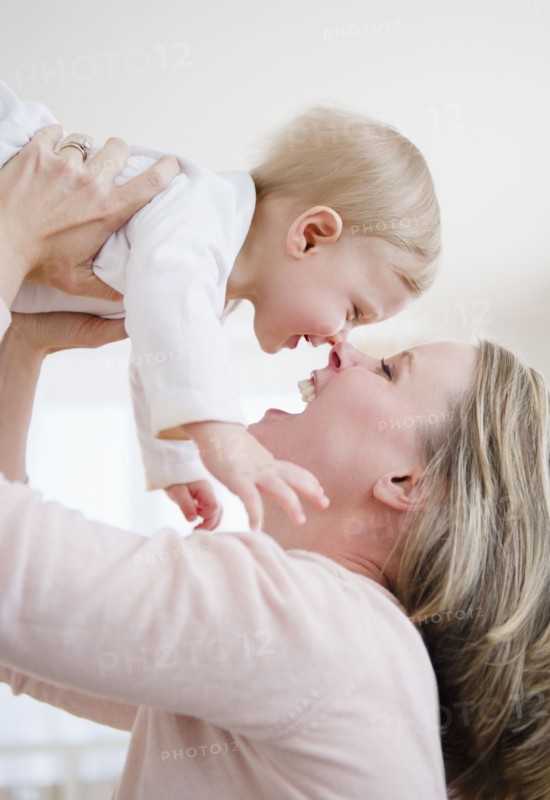Mother lifting son (6-11 months). 
Photo: Jamie Grill