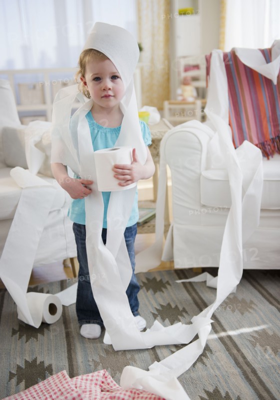Girl (2-3) wrapped with toilet paper standing in living room. 
Photo: Jamie Grill