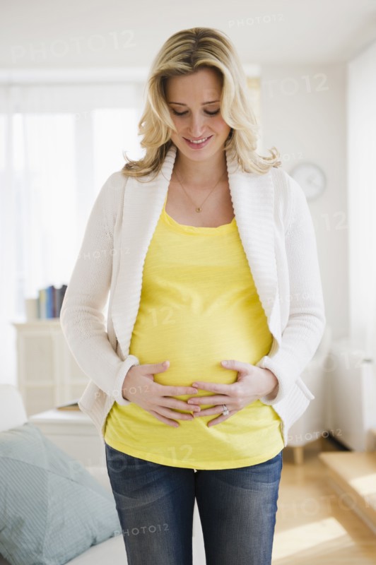 Pregnant woman touching belly. 
Photo: Jamie Grill