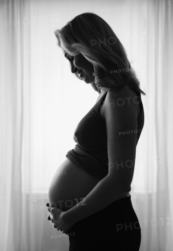 Pregnant woman standing by window. 
Photo: Jamie Grill