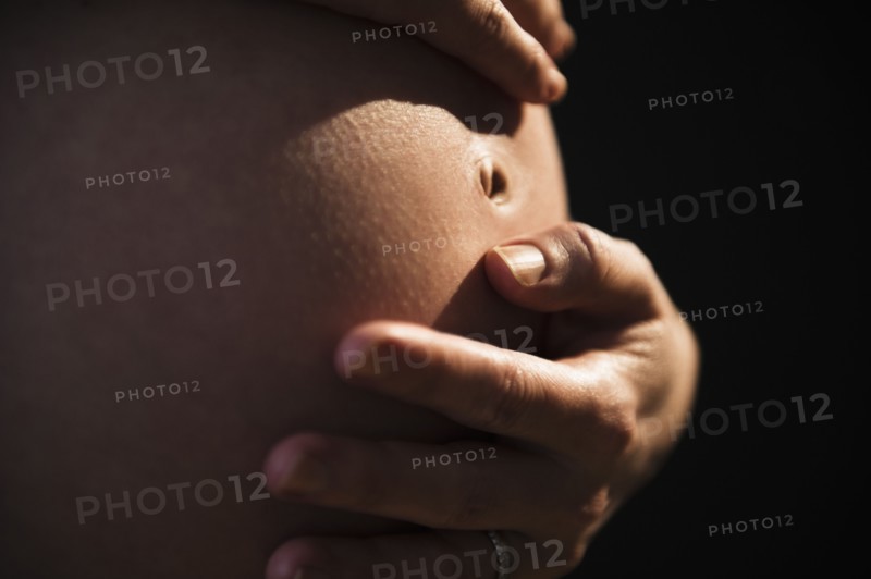 Belly of pregnant woman. 
Photo : Jamie Grill