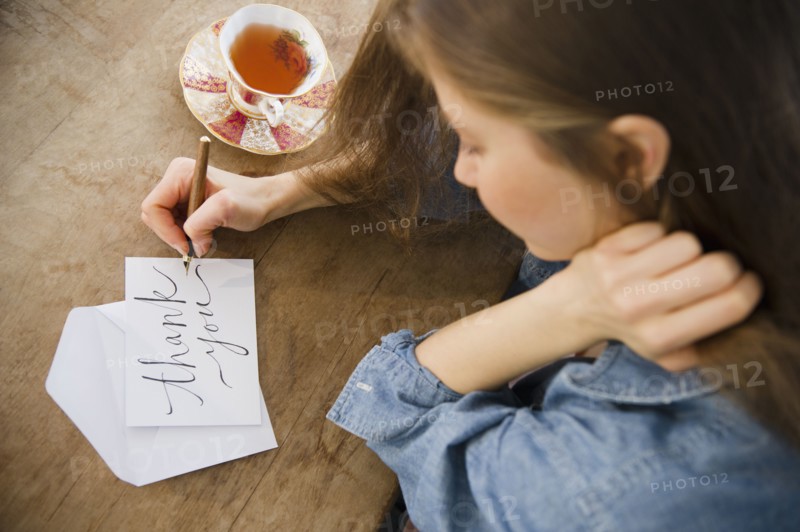 Woman writing greeting card. 
Photo: Jamie Grill