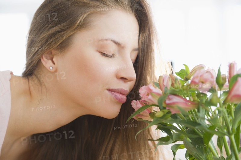 Woman smelling flowers. 
Photo : Jamie Grill