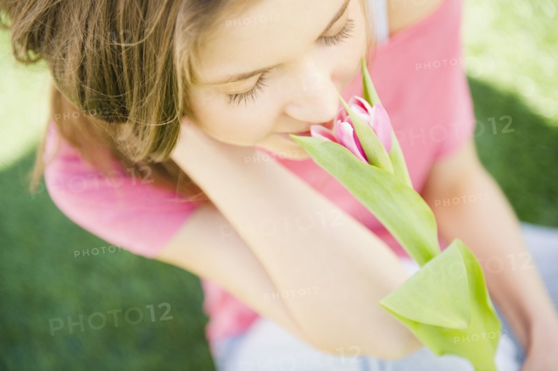 Woman smelling flower. 
Photo : Jamie Grill