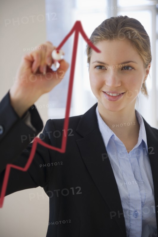 Woman drawing graph on glass . 
Photo: Jamie Grill