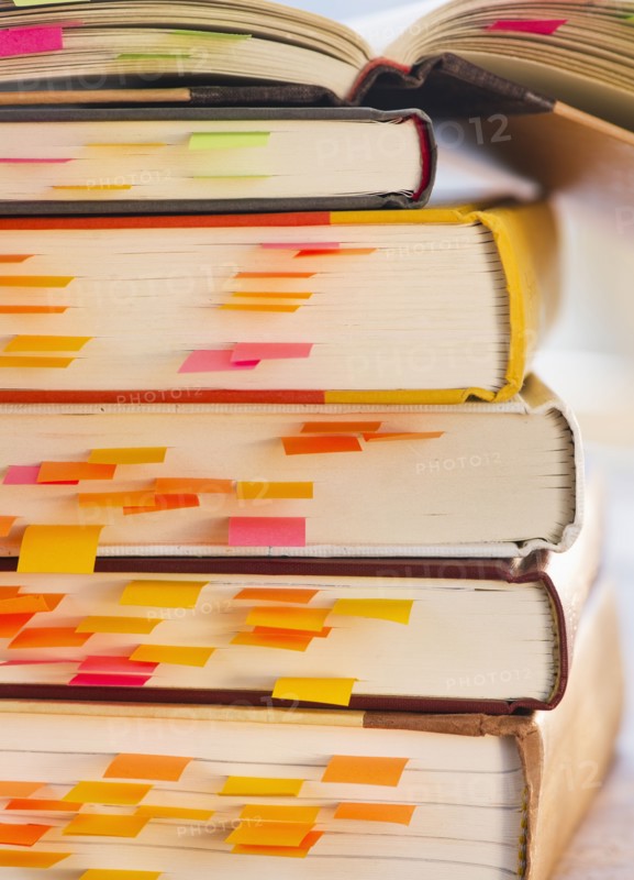 Close up adhesive notes in books, studio shot. 
Photo: Daniel Grill