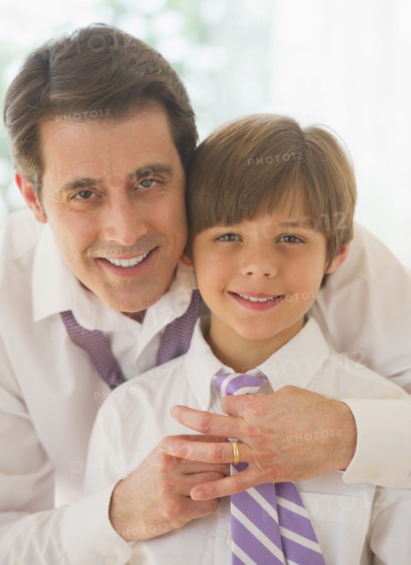 Father helping son (10-11 years) to tie tie. 
Photo: Daniel Grill