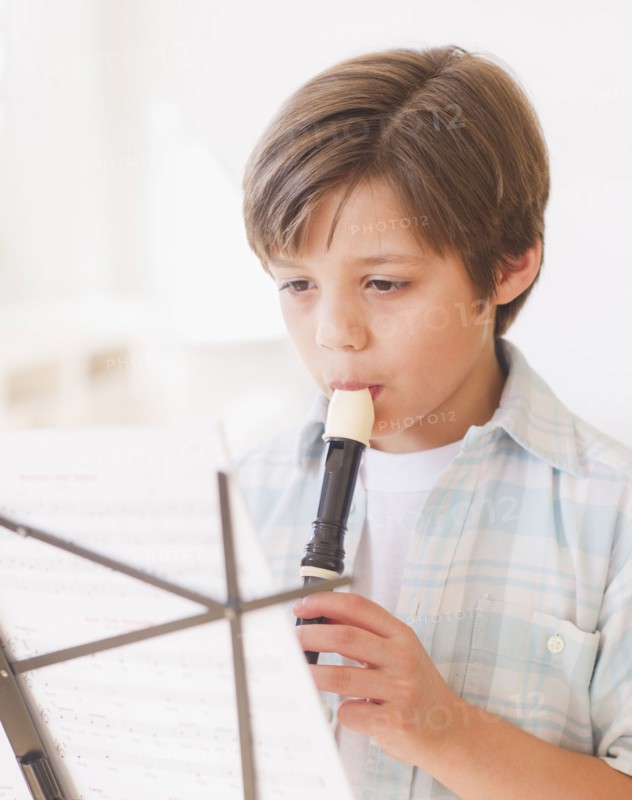 Boy (10-11 years) playing flute. 
Photo : Daniel Grill