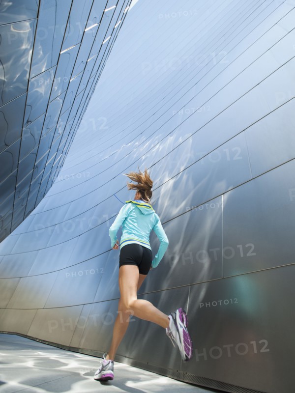 USA, California, Los Angeles, Young woman jogging in city.