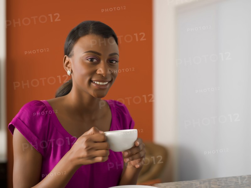 Young woman with cup of coffee. 
Photo: Dan Bannister