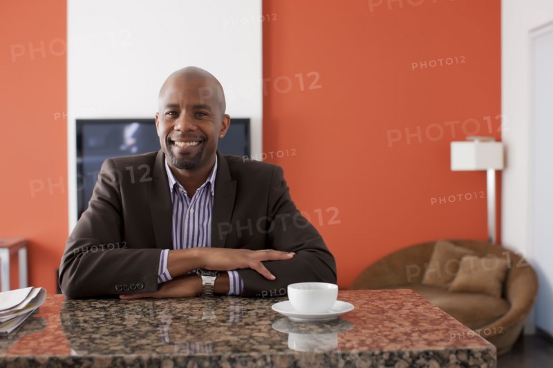Man enjoying coffee at home. 
Photo : Dan Bannister