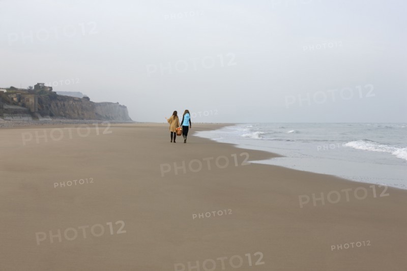 France, Pas-de-Calais, Escalles, Two women strolling on empty beach. 
Photo: Jan Scherders