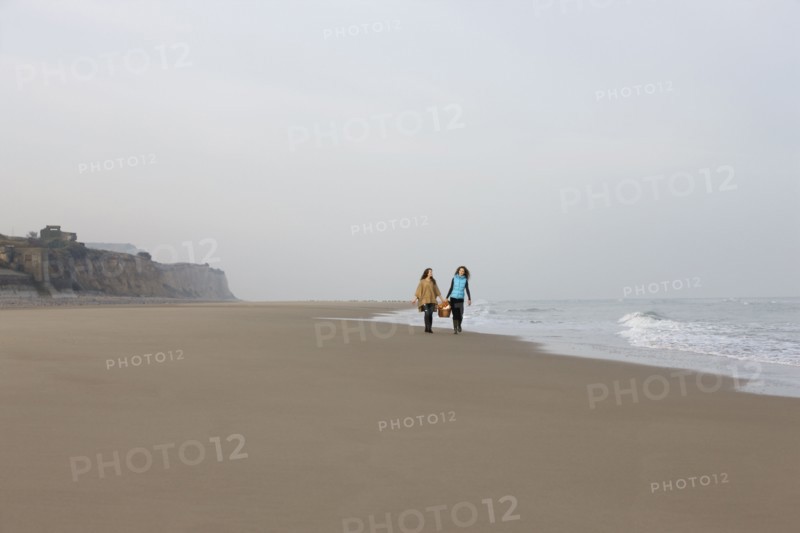 France, Pas-de-Calais, Escalles, Two women strolling on empty beach. 
Photo: Jan Scherders