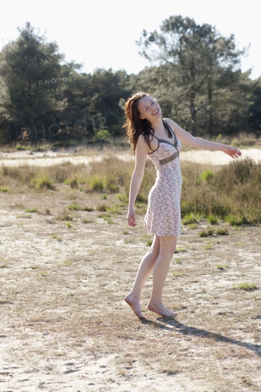 Belgium, Kalmthoutse Heide, Young woman walking barefoot. 
Photo : Jan Scherders