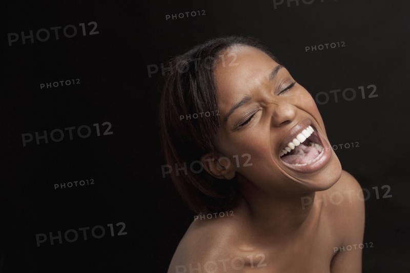 Young woman bursting with laugh. 
Photo: Jan Scherders