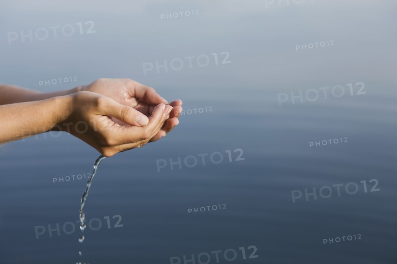 Cupped hands holding water from lake. 
Photo: Jan Scherders