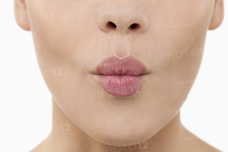 Close-up of female lips blowing kiss. 
Photo : Jan Scherders
