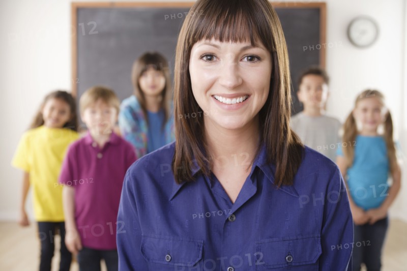 Teacher with group of pupils in front of blackboard. 
Photo : Rob Lewine