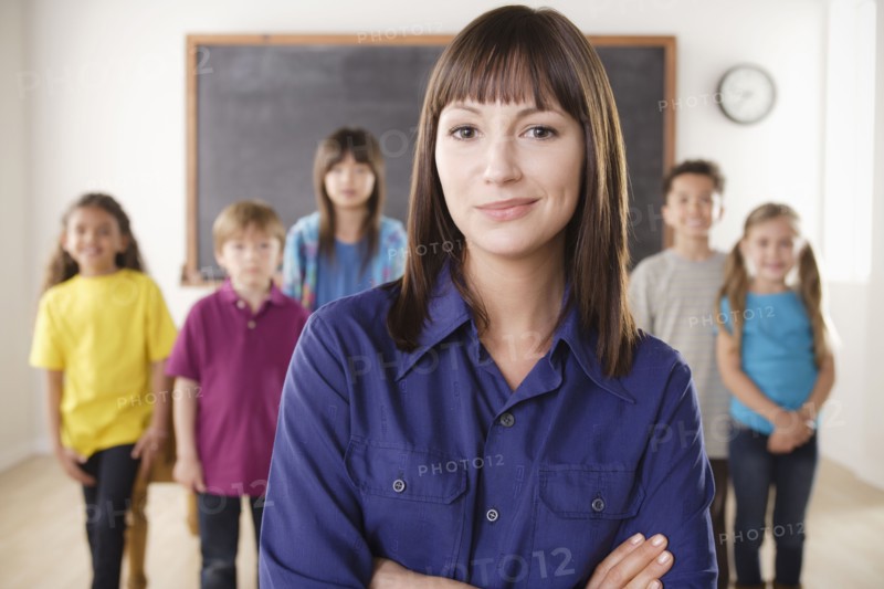Teacher with group of pupils in front of blackboard. 
Photo: Rob Lewine