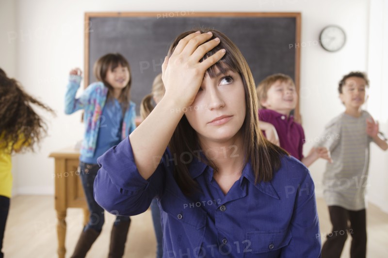 Teacher with group of pupils in front of blackboard. 
Photo: Rob Lewine