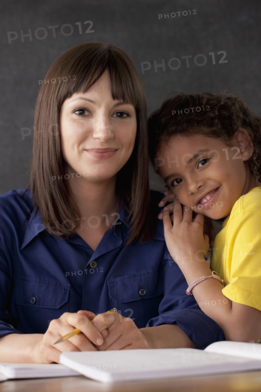 Teacher with smiling schoolgirl. 
Photo: Rob Lewine