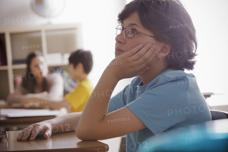 Portrait of schoolboy (10-11) contemplating. 
Photo : Rob Lewine