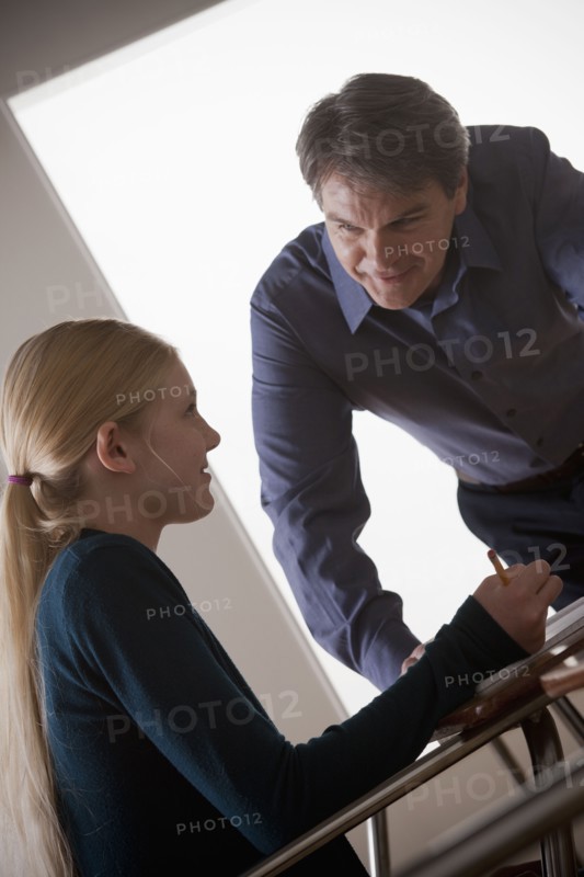 Teenage girl (14-15) with teacher at school. 
Photo : Rob Lewine