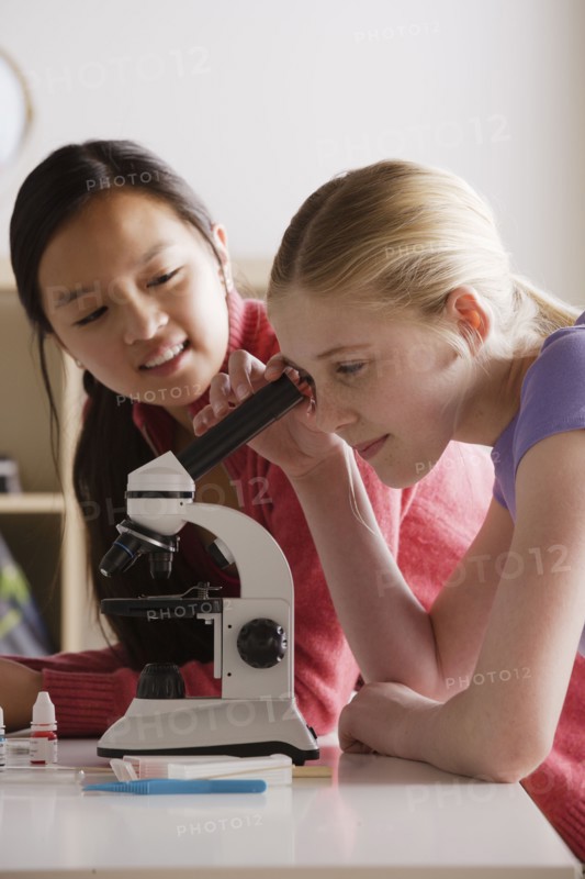 Teenage girls (14-15) working with microscope. 
Photo : Rob Lewine