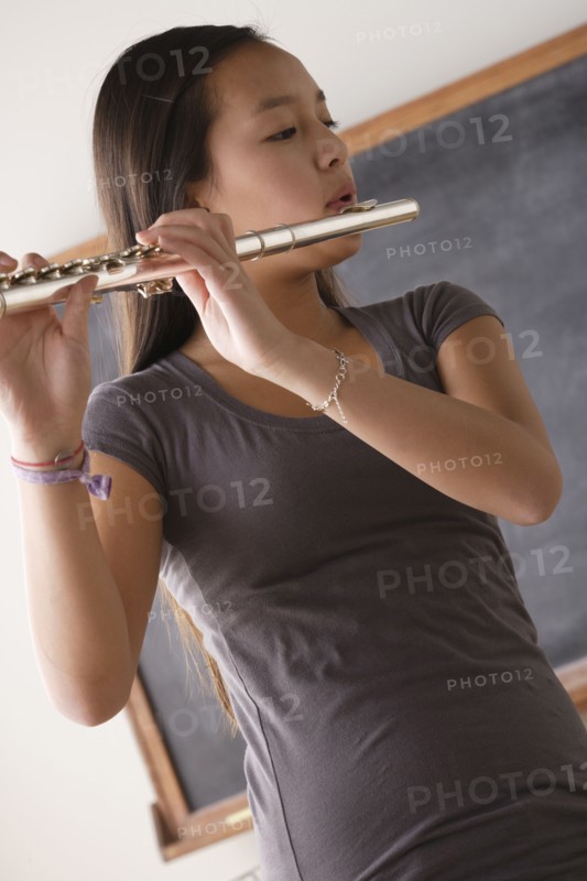 Teenage girl (14-15) playing flute. 
Photo : Rob Lewine