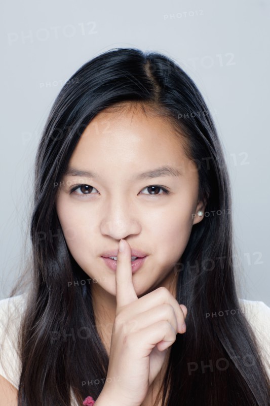 Portrait of teenage girl (14-15), studio shot. 
Photo: Rob Lewine