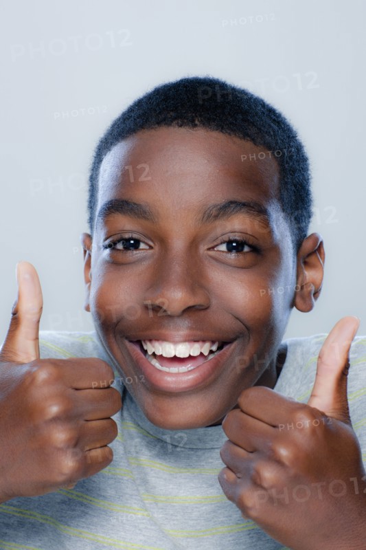 Portrait of teenage boy (14-15), studio shot. 
Photo: Rob Lewine